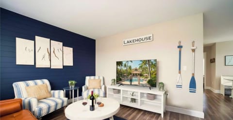 Cozy lakehouse lounge with smart TV, leather sofa, and coastal vibe