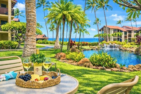Lush oceanfront lawn at Papakea Resort invites you to lounge steps from the Pacific, with palms, koi ponds, and sunset views just beyond. PKD-104