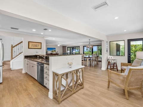 The dining area flows into the kitchen, set up for meals together.