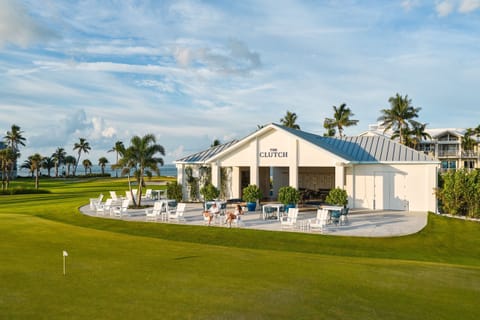 Overlooking the greens, The Clutch Clubhouse sets the scene for relaxed, sunset-lit dining after a day on the course.