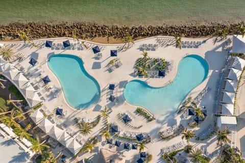 Cabanas and poolside seating line the deck, offering shade between swims.