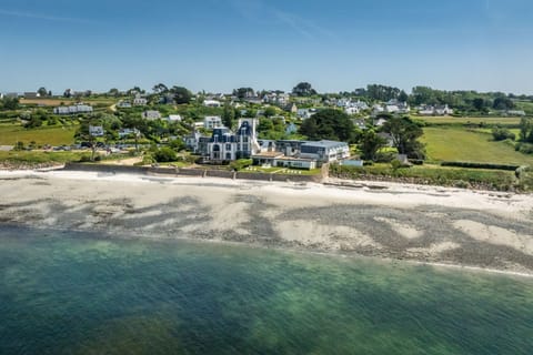The beach sits right at the edge of the grounds, with the Breton hillside rising behind.