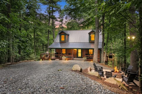 As dusk settles over Willow Ridge, the fire pit crackles to life on the porch, string lights flicker against the treeline, and the surrounding woods go quiet — the kind of evening that makes you forget your phone has a signal at all.