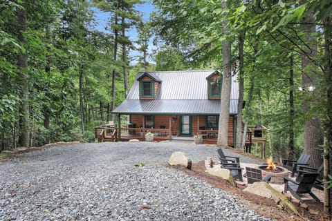 As dusk settles over Willow Ridge, the fire pit crackles to life on the porch, string lights flicker against the treeline, and the surrounding woods go quiet — the kind of evening that makes you forget your phone has a signal at all.