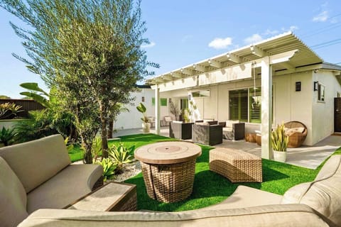 Relax in this inviting backyard retreat that features a cozy fire pit and comfortable lounge seating.