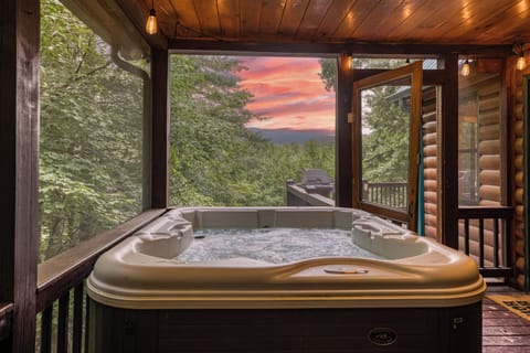 Hot Tub facing sunset inside the screened in porch