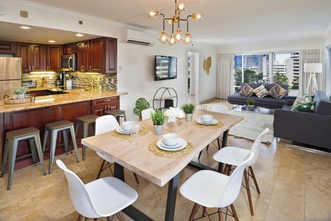 Dining adjacent to the living area which has 2 futon sofas that convert to 2 single sofabeds