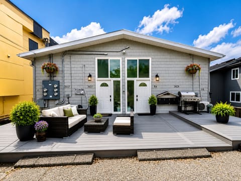 Spacious private deck with lounge seating, grill, and modern curb appeal