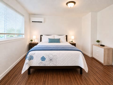 Bright, cozy bedroom with AC, natural light, and stylish modern touches