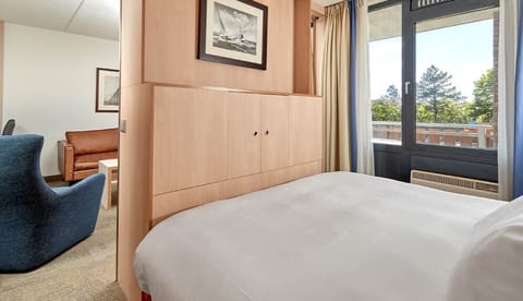 Stretch out in a serene suite with leafy outdoor views.
