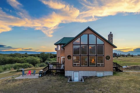Golden hour at Bear Creek Cabin — the sky ablaze as your Teton hideaway comes into view. This first glimpse is the moment vacation finally feels real.