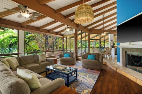 Vaulted wood beams rise over the living room where the group lands after the beach.