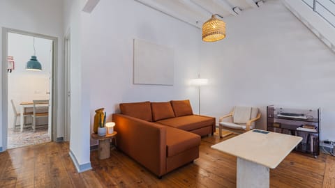 Bright living room designed for relaxing after a day exploring the city. Featuring warm wooden floors, contemporary décor, a comfortable chaise lounge sofa, and plenty of natural light.
#LovelyStay #LisbonApartment #DesignStay #TravelPortugal