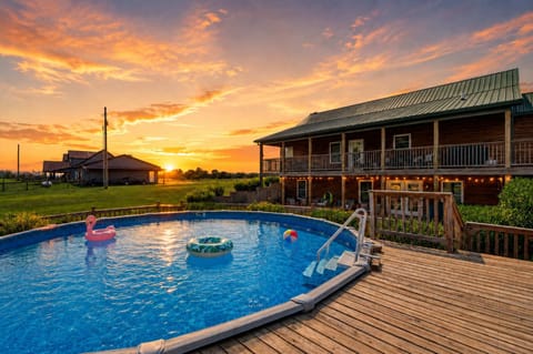 Backyard: This spacious backyard offers the best of both worlds with an outdoor pool for daytime fun and a welcoming firepit seating area for relaxing nights under the sky.