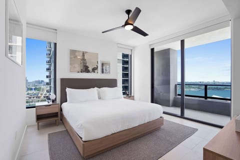 Comfortable king bed with natural light and city views.