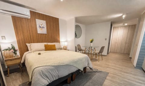 Cozy modern studio with plush king bed, dining nook, and stylish finishes