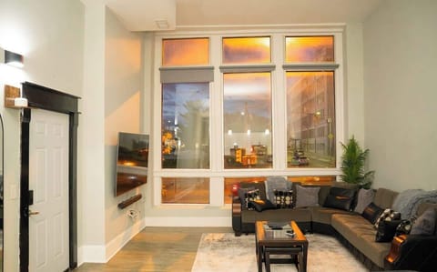 Bright and inviting living room with comfortable seating and a smart TV, perfect for relaxing after a long day.