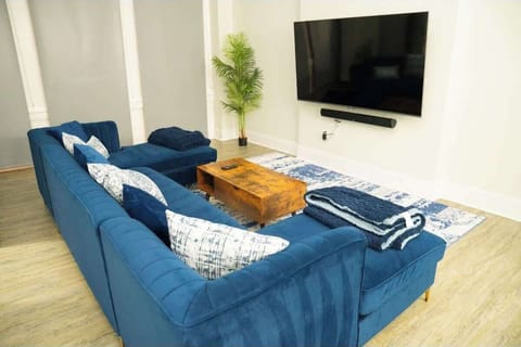 Relax in our spacious living room featuring a plush velvet sectional and Smart TV for the ultimate movie night.