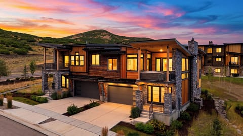 Exterior front view of the modern mountain home at sunset.