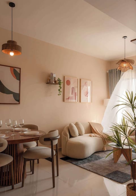Spacious modern designed ilving room consisting of a 2m plush sofa, 1.2m round dining table with 4 chairs and an armchair for comfort.