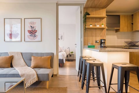 Cozy living space with modern decor and a convenient kitchen area, perfect for relaxing after exploring the city.