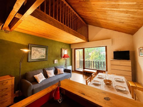 Rich green walls set a warm tone in the living room, with a large window looking out over the resort.