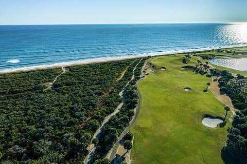 Championship golf course running along the Atlantic shoreline from above