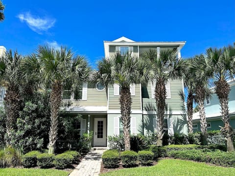 Palm-lined entrance with a covered walkway — the pool and spa courtyard are just through the gate