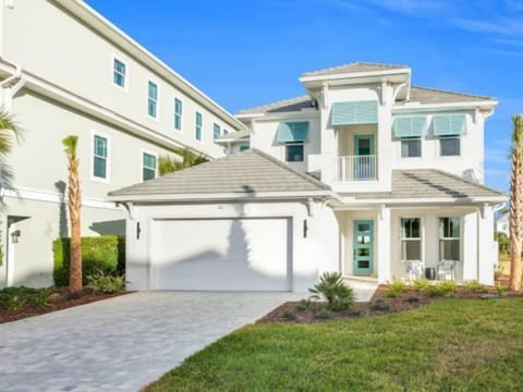 Exterior view of the home with waterfront access and manicured landscaping