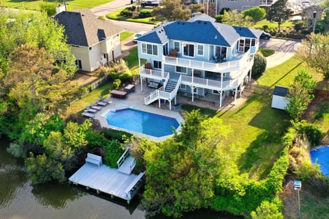Waterfront retreat with pool, private dock, and multi-level decks