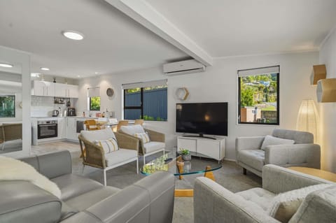 The living room is comfy. It has a smart TV and plenty of seating. It is open plan with the kitchen. 