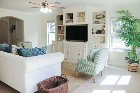 Bright & inviting living room with comfy seating and a large TV.