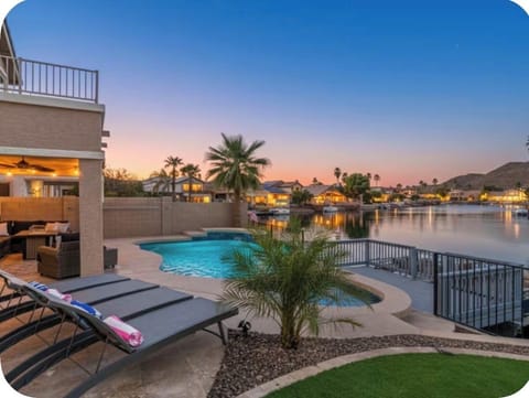 Heated private pool, covered lounge area, and sunset views across Arrowhead Lakes