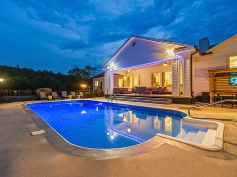 Enjoy the private pool surrounded by a spacious patio, comfortable lounge seating, and beautiful evening views—perfect for relaxing and making the most of your stay.