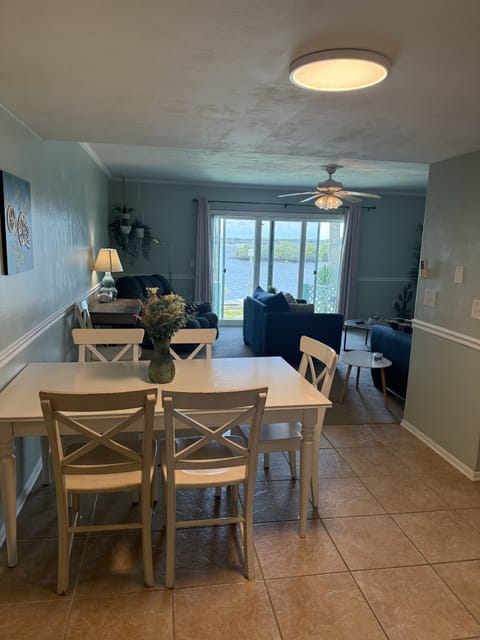 Bright open dining and living space with natural light and patio access