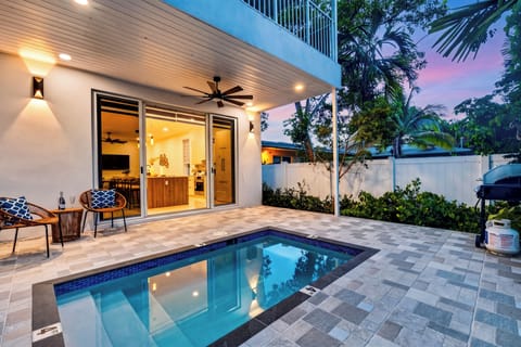 Twilight poolside vibes with glowing lights, inviting seating, and a private courtyard for relaxed Fort Lauderdale evenings.