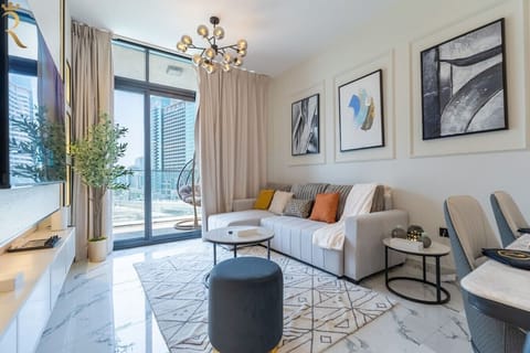 Stylish living room with a plush sectional sofa, curated wall art, and floor-to-ceiling windows showcasing stunning skyline views.