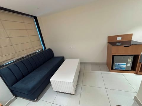 Family Suite, Balcony, Hill View | Living area | 21-inch Smart TV with cable channels
