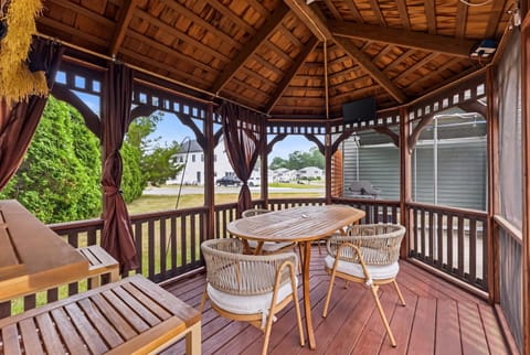 Sip morning coffee with a breeze rolling through — this screened gazebo brings the outdoors in without the bugs.