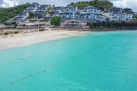 Picture morning swims steps from your room along calm shores.