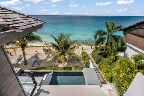 Soak in sweeping turquoise views above the private beach.