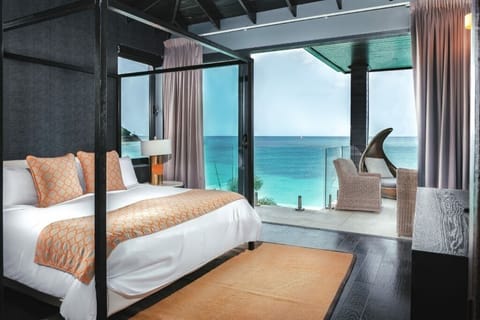 Wake up to panoramic sea views from your canopy bed.