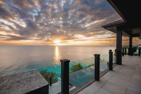 Dive into your private infinity pool above turquoise ocean views.