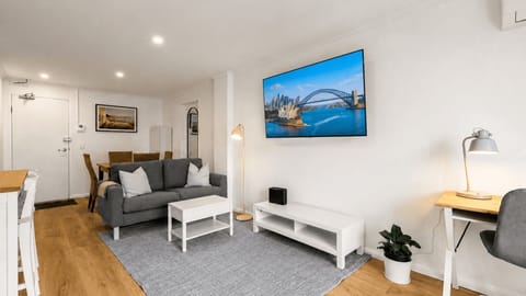 Comfortable open-plan studio with queen bed and living area.