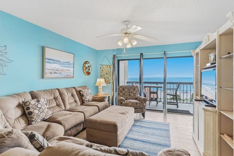 Relax in this cheerful coastal living room where ocean breezes and panoramic sea views create your perfect beach escape. Sink into plush seating while enjoying sweeping views from your private balcony.