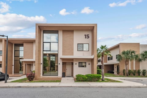Experience a modern vacation home with a stunning facade and large windows that invite natural light. The sleek design and calming neutral tones, enhanced by lush greenery, offer a refreshing ambiance for your serene getaway.