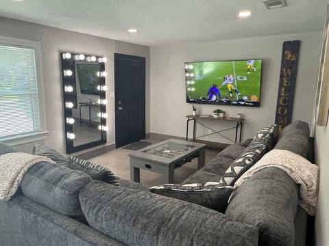 Spacious living room with 75 inch smart TV