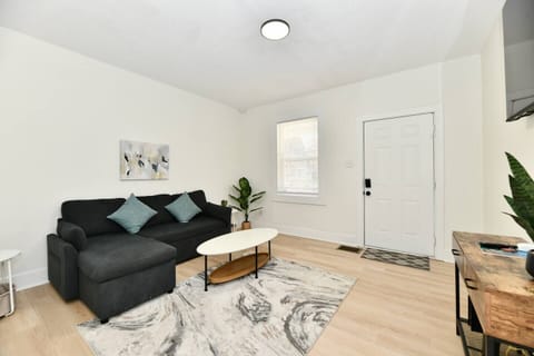 A warm and inviting living room perfect for unwinding after a day in the city. Comfortable seating, a smart TV, and plenty of natural light make this the ideal spot to relax and recharge.