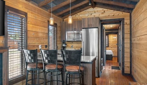 Prepare meals in Cabin 2’s well-equipped kitchen, complete with stainless steel appliances and comfortable bar seating.