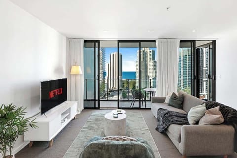 Unwind in a light-filled lounge that seamlessly connects cozy indoor entertainment with spectacular coastal city views.